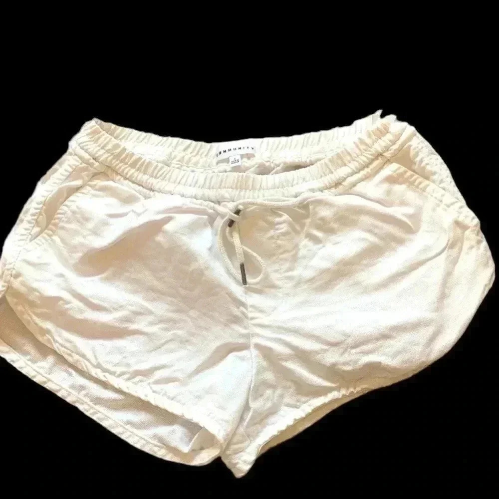 Community bright white shorts w elasticized waistband, front tie, four p…